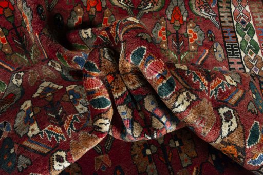 Corner detail of 2000s Shiraz rug showing border pattern and Wool pile