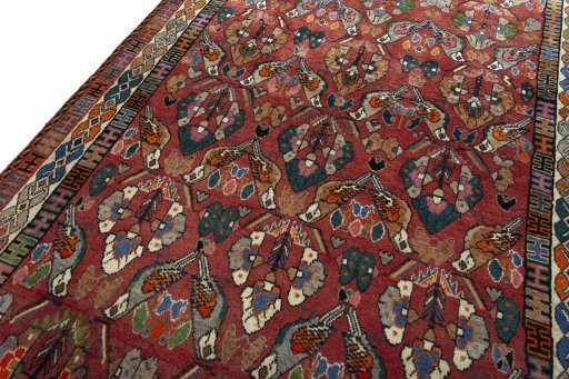 Backside of handmade 2000s Shiraz rug showing knot structure and weave density