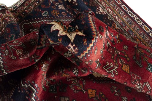 Corner detail of 2000s Shiraz rug showing border pattern and Wool pile