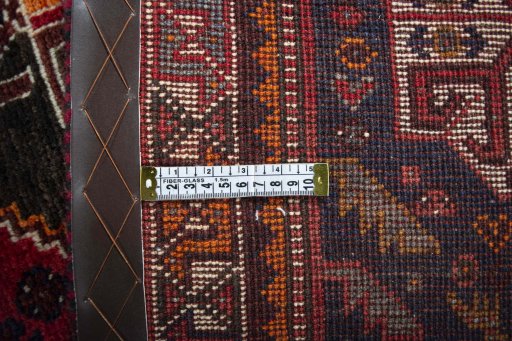 Backside of handmade 2000s Shiraz rug showing knot structure and weave density