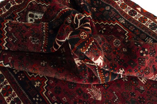 Corner detail of 2000s Shiraz rug showing border pattern and Wool pile