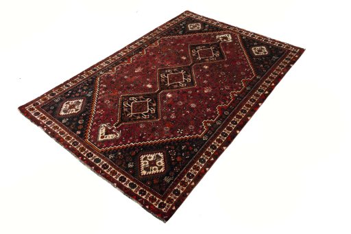 Corner detail of 2000s Shiraz rug showing border pattern and Wool pile