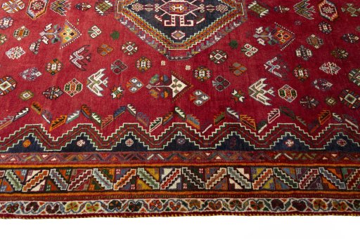 Corner detail of 2000s Shiraz rug showing border pattern and Wool pile