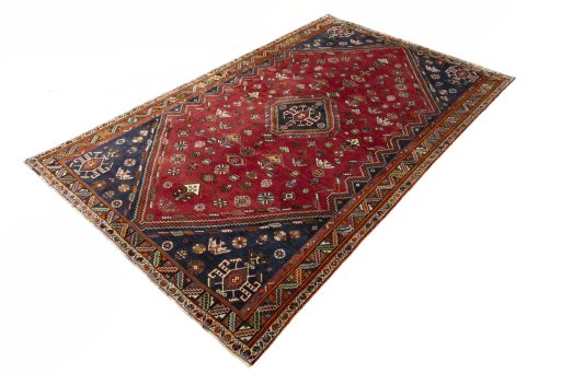 Corner detail of 2000s Shiraz rug showing border pattern and Wool pile