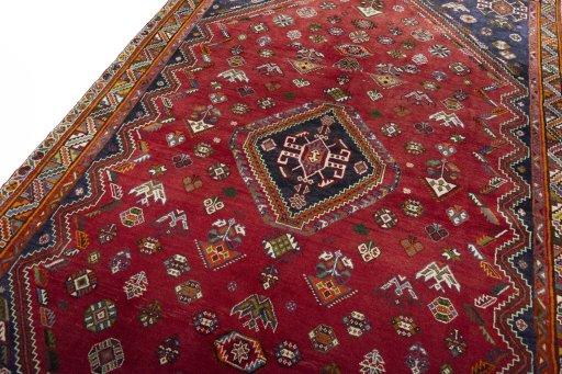 Backside of handmade 2000s Shiraz rug showing knot structure and weave density