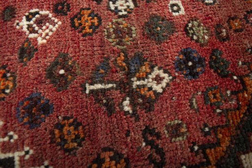 Corner detail of 2000s Shiraz rug showing border pattern and Wool pile