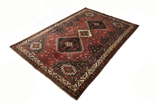 Corner detail of 2000s Shiraz rug showing border pattern and Wool pile
