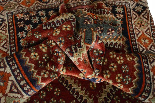 Corner detail of 2000s Shiraz rug showing border pattern and Wool pile