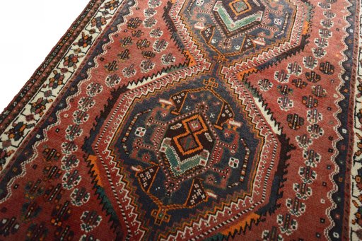 Backside of handmade 2000s Shiraz rug showing knot structure and weave density