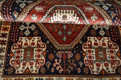 Corner detail of 2000s Shiraz rug showing border pattern and Cotton pile