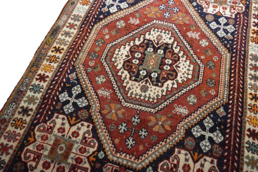 Backside of handmade 2000s Shiraz rug showing knot structure and weave density