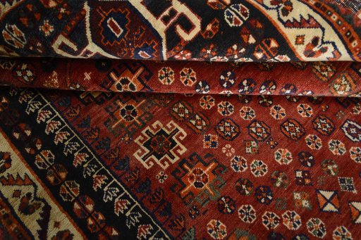Corner detail of 2000s Shiraz rug showing border pattern and Wool pile