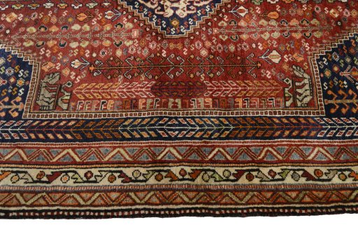 Corner detail of 2000s Shiraz rug showing border pattern and Wool pile