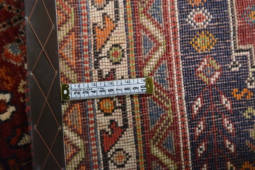 Backside of handmade 2000s Shiraz rug showing knot structure and weave density