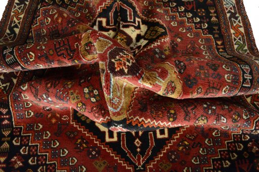 Corner detail of 2000s Shiraz rug showing border pattern and Wool pile