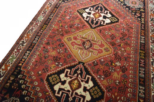 Backside of handmade 2000s Shiraz rug showing knot structure and weave density