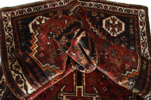 Corner detail of 2000s Shiraz rug showing border pattern and Wool pile