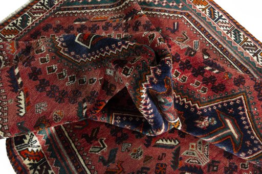 Corner detail of 2000s Shiraz rug showing border pattern and Wool pile