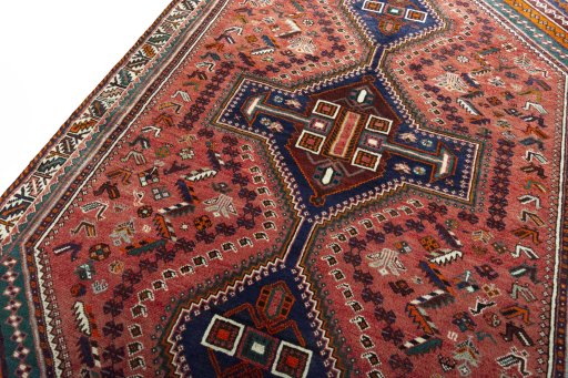 Backside of handmade 2000s Shiraz rug showing knot structure and weave density