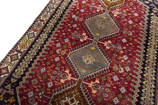 Backside of handmade 2000s Shiraz rug showing knot structure and weave density