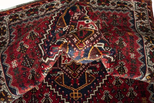 Corner detail of 2000s Shiraz rug showing border pattern and Wool pile