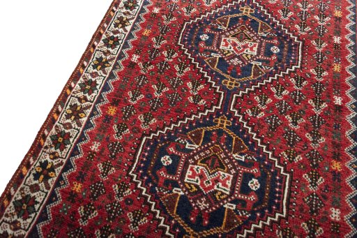 Backside of handmade 2000s Shiraz rug showing knot structure and weave density