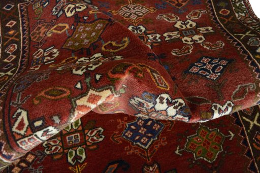 Corner detail of 2000s Shiraz rug showing border pattern and Wool pile