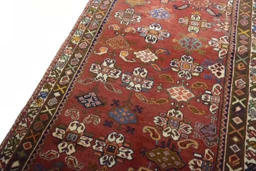 Backside of handmade 2000s Shiraz rug showing knot structure and weave density