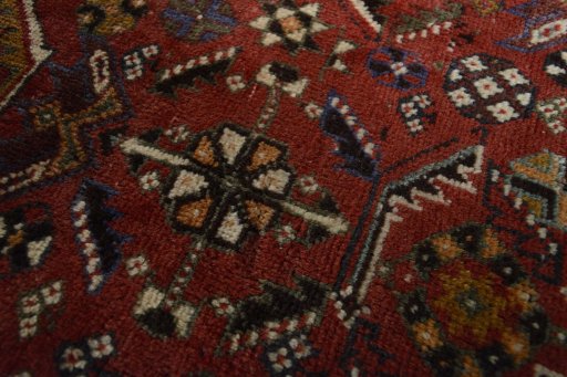 Backside of handmade 2000s Shiraz rug showing knot structure and weave density