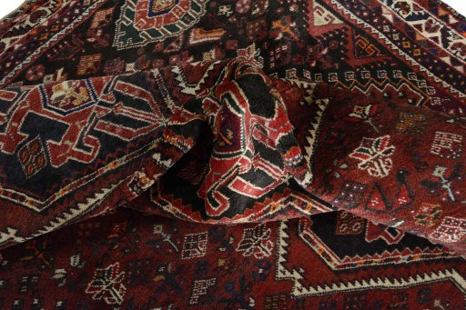 Corner detail of 2000s Shiraz rug showing border pattern and Wool pile