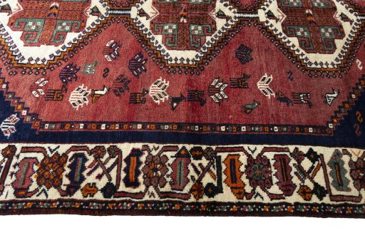 Corner detail of 2000s Shiraz rug showing border pattern and Wool pile