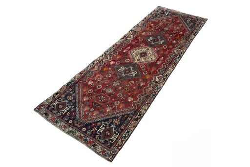 Corner detail of 2000s Shiraz rug showing border pattern and Wool pile