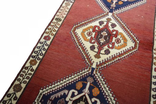 Backside of handmade 2000s Shiraz rug showing knot structure and weave density