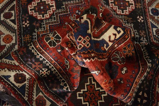 Surface texture of 2000s Shiraz rug with natural Wool and intricate pattern