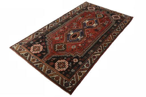 Corner detail of 2000s Shiraz rug showing border pattern and Wool pile