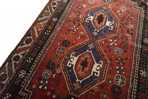 Backside of handmade 2000s Shiraz rug showing knot structure and weave density