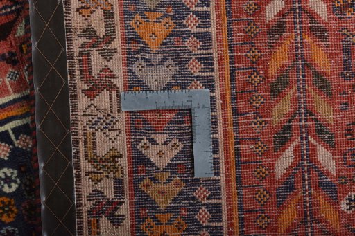 Backside of handmade 2000s Shiraz rug showing knot structure and weave density