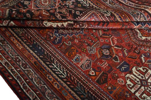 Corner detail of 2000s Shiraz rug showing border pattern and Wool pile