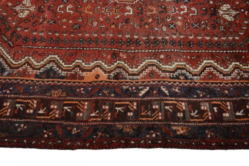 Corner detail of 2000s Shiraz rug showing border pattern and Wool pile