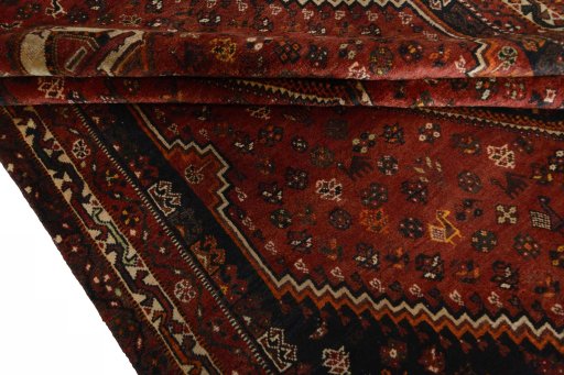 Corner detail of 2000s Shiraz rug showing border pattern and Wool pile