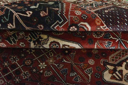 Corner detail of 2000s Shiraz rug showing border pattern and Wool pile