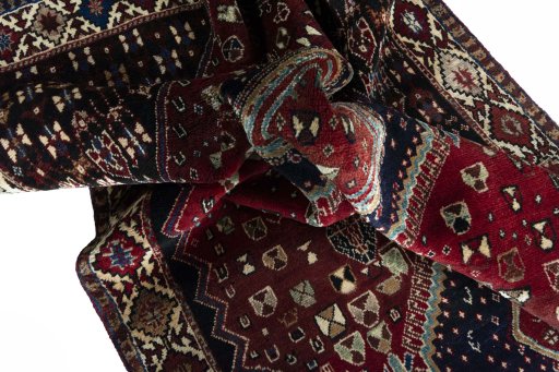 Corner detail of 2000s Shiraz rug showing border pattern and Wool pile
