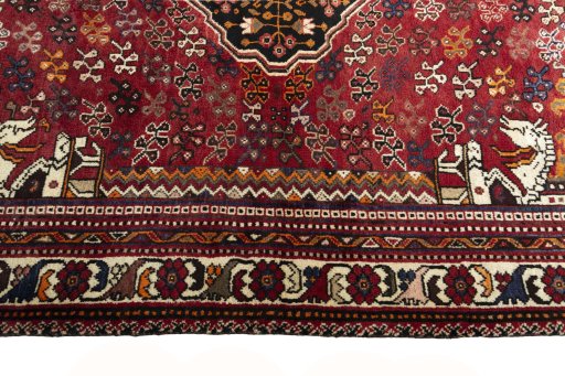 Corner detail of 2000s Shiraz rug showing border pattern and Wool pile
