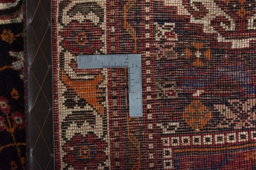 Backside of handmade 2000s Shiraz rug showing knot structure and weave density