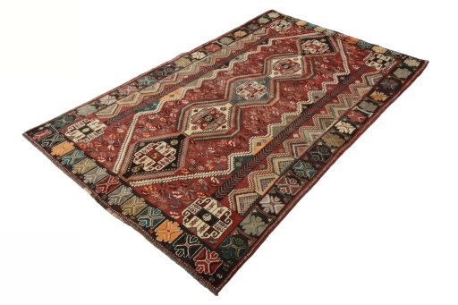 Corner detail of 2000s Shiraz rug showing border pattern and Wool pile