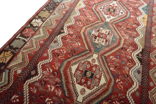 Backside of handmade 2000s Shiraz rug showing knot structure and weave density