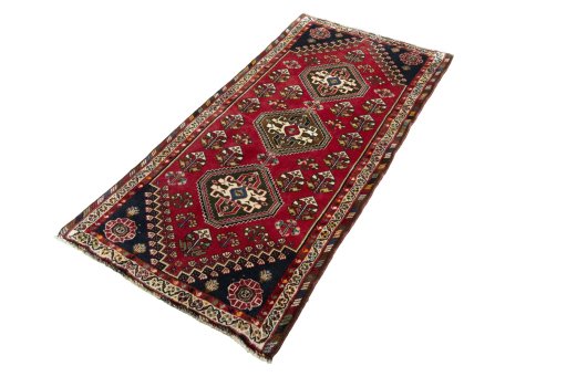 Corner detail of 2000s Shiraz rug showing border pattern and Wool pile