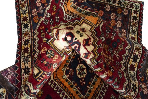 Corner detail of 2000s Shiraz rug showing border pattern and Wool pile