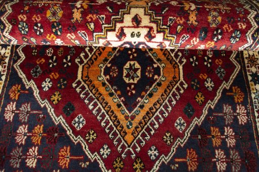 Full view of 2000s Shiraz rug from Iran / Persia, 187 × 110 cm in Red tones