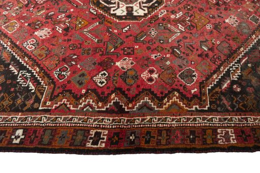 Corner detail of 2000s Shiraz rug showing border pattern and Wool pile